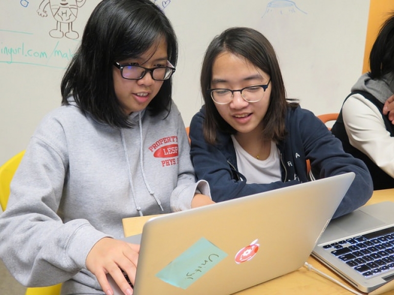 female students working together on the computer