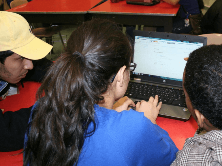 Students using the computer to visit different website using URLs and observe differences